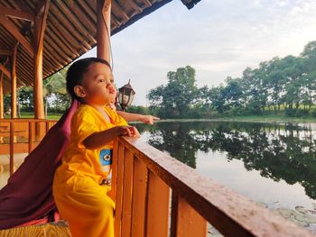 Side view of boy looking at lake