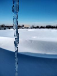 Close-up of ice crystals against blue sky