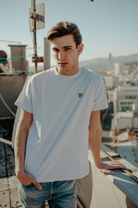 Young man standing in city