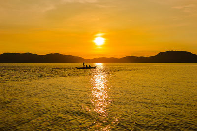 Scenic view of sea against orange sky