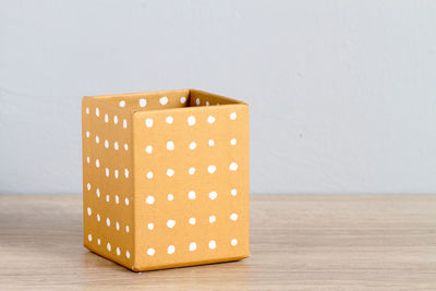 Close-up of box on table against white background