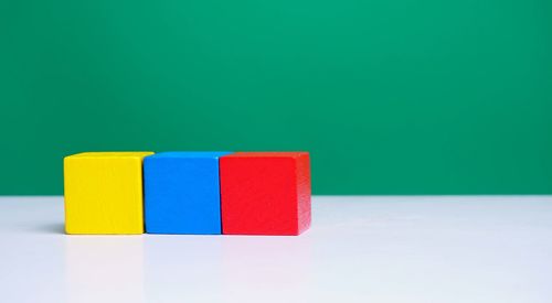 Close-up of multi colored toy on table against blue background