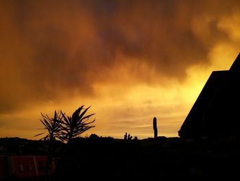 Silhouette of built structure at sunset