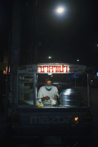 Portrait of man standing in restaurant at night