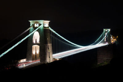 Low angle view of illuminated bridge at night