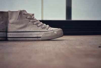 Low section of shoes on hardwood floor