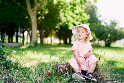 Cute boy sitting on grass