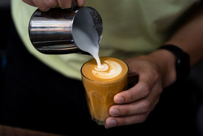 Close-up of hand holding coffee cup