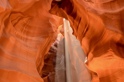 Digital composite image of woman standing in canyon