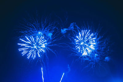 Low angle view of firework display at night