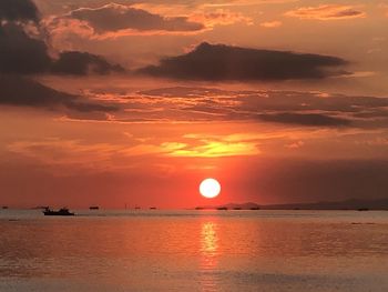 Scenic view of sea against romantic sky at sunset