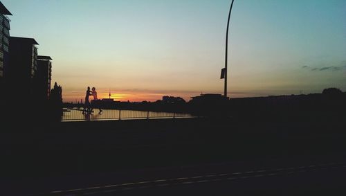 Silhouette built structure at sunset