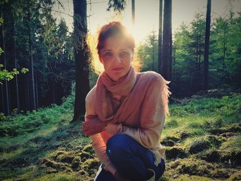 Portrait of beautiful young woman in forest