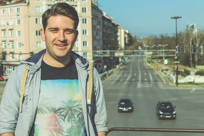 Portrait of young man standing in car