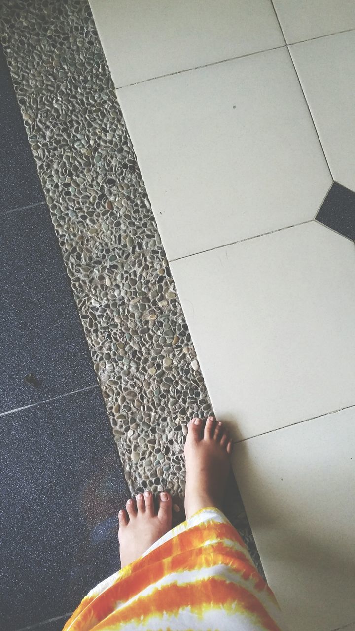 person, low section, personal perspective, barefoot, lifestyles, human foot, part of, leisure activity, high angle view, standing, unrecognizable person, men, cropped, human limb, tiled floor