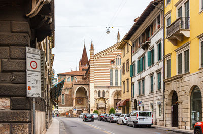 Street amidst buildings against sky in city