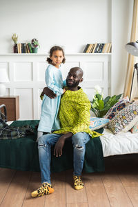 Portrait of father and daughter at home