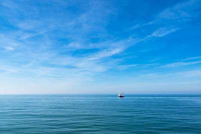 Sailboat in sea against sky