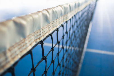 Close-up of tennis net on court