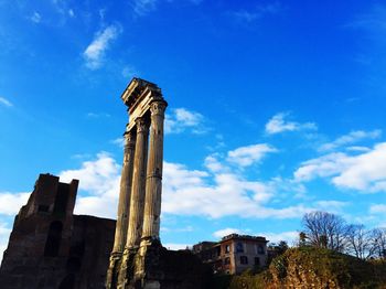 Low angle view of building against cloudy sky