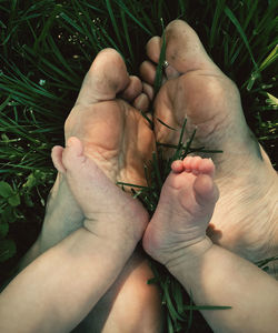 Mother and child feet embrace 