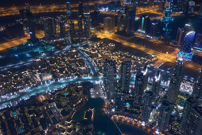 High angle view of city lit up at night