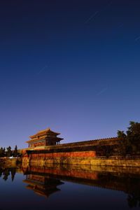 Illuminated built structure against blue sky