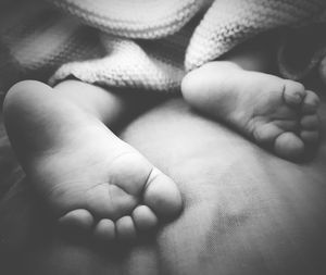 Close-up of baby feet on bed