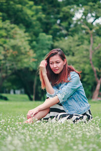 Young woman sitting on grass