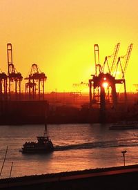 Boats in sea at sunset