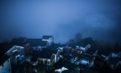 High angle view of buildings against sky at night