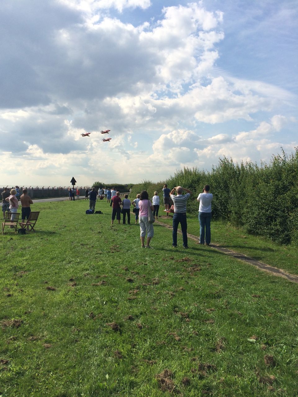 cloud - sky, group of people, sky, grass, real people, nature, plant, men, adult, land, crowd, women, day, field, large group of people, leisure activity, standing, lifestyles, environment, outdoors