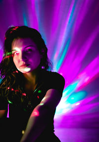 Portrait of woman in illuminated nightclub