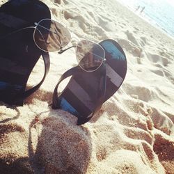 High angle view of sunglasses on beach