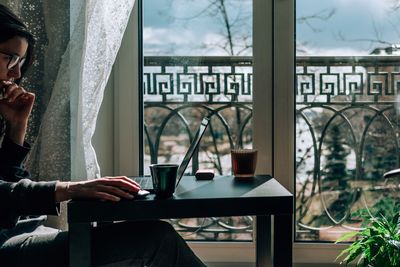 Young woman using laptop at table