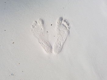 High angle view of heart shape on sand