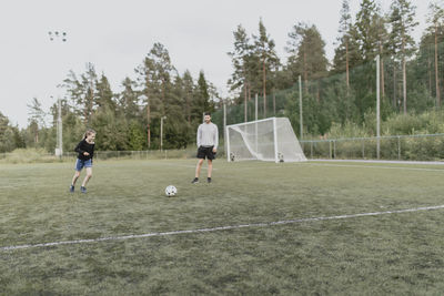 Father and daughter playing football