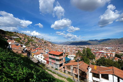 High angle view of houses in town against sky