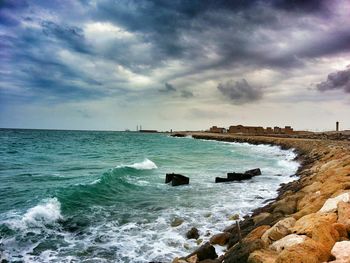 Scenic view of sea against cloudy sky