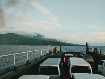 Scenic view of sea and mountains against sky