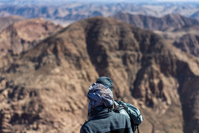 Hikers standing against mountains