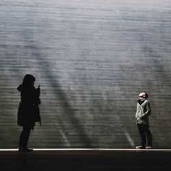 Full length of woman standing by railing