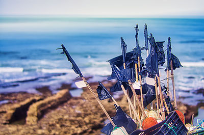 Close-up of wooden post at beach against sky