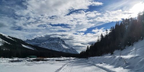 Scenic view of snow covered mountains against sky