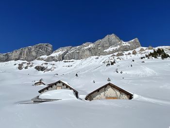 Scenic view of snowcapped mountains against blue sky