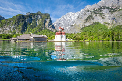 Scenic view of lake by mountain against sky