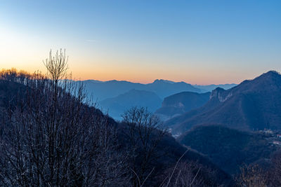 Scenic view of snowcapped mountains against sky during sunset