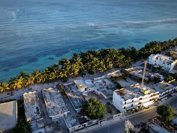 High angle view of buildings by sea against sky