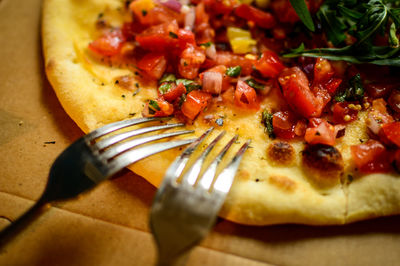 Close-up of pizza with forks
