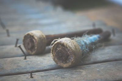 Close-up of rusty rope on wooden table